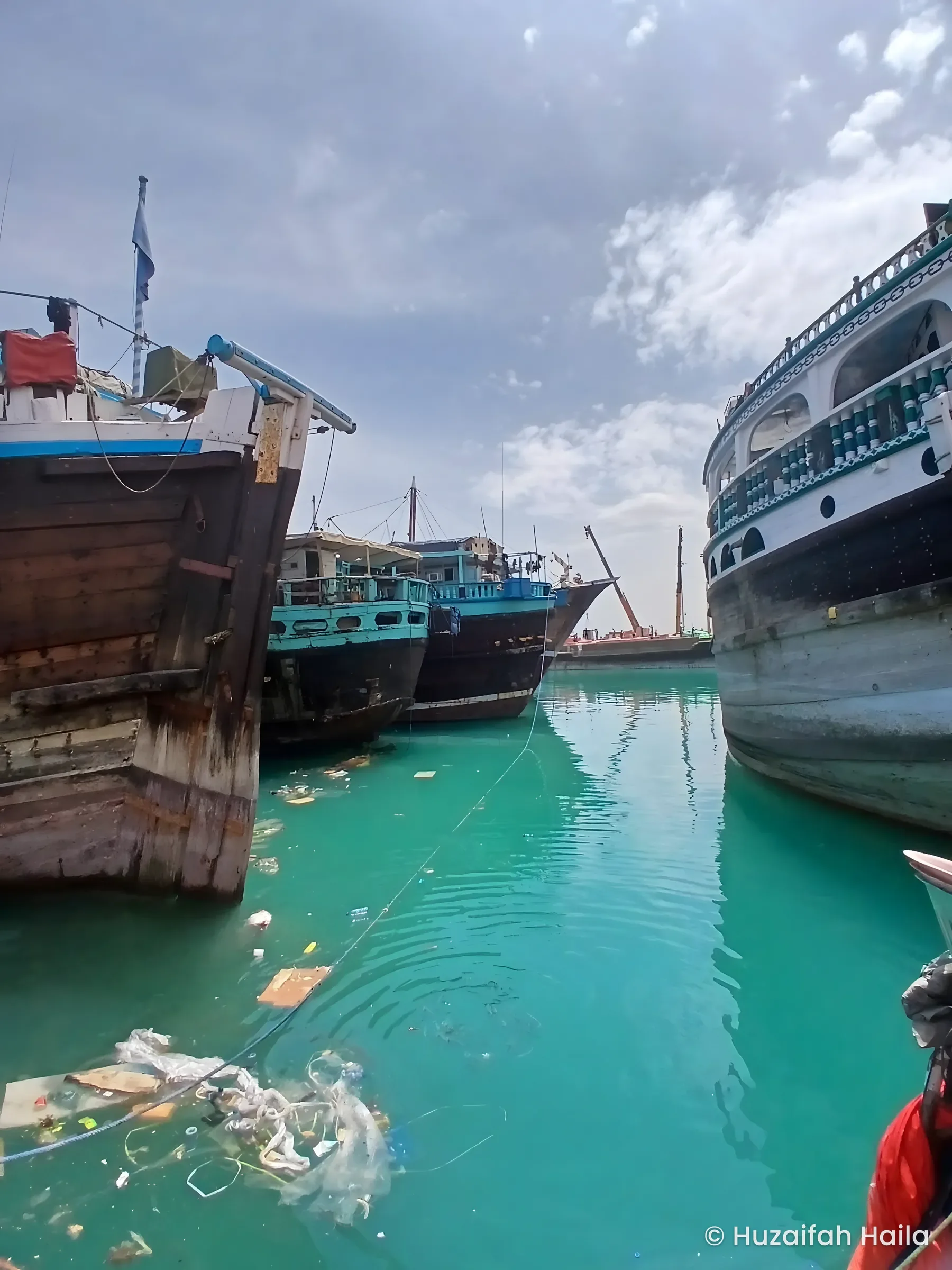 Wooden dhows moored in the turquoise water of Bosaso Port, Somalia