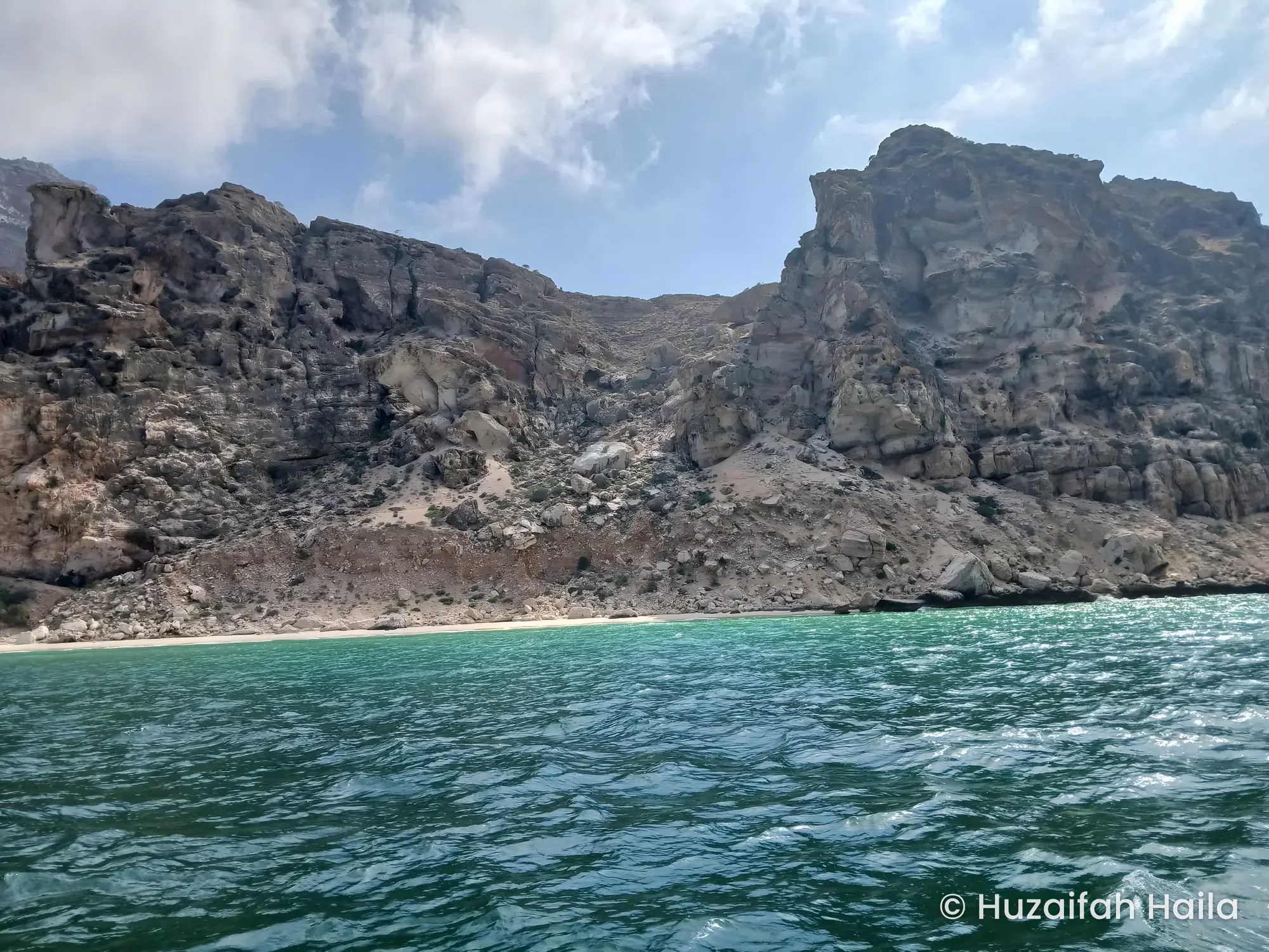 Rocky cliffs above turquoise water