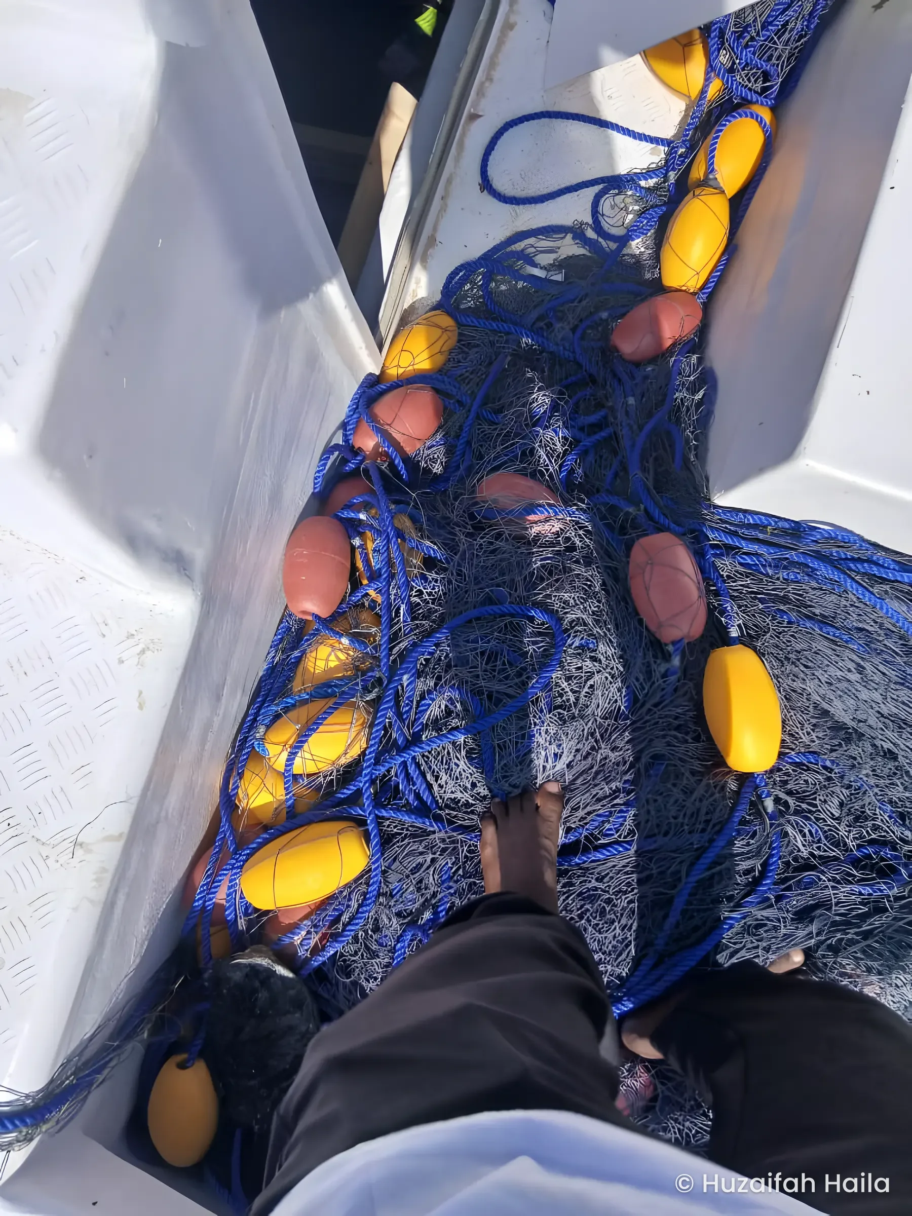 Fishing nets and yellow floats on the deck of the Horaad boat