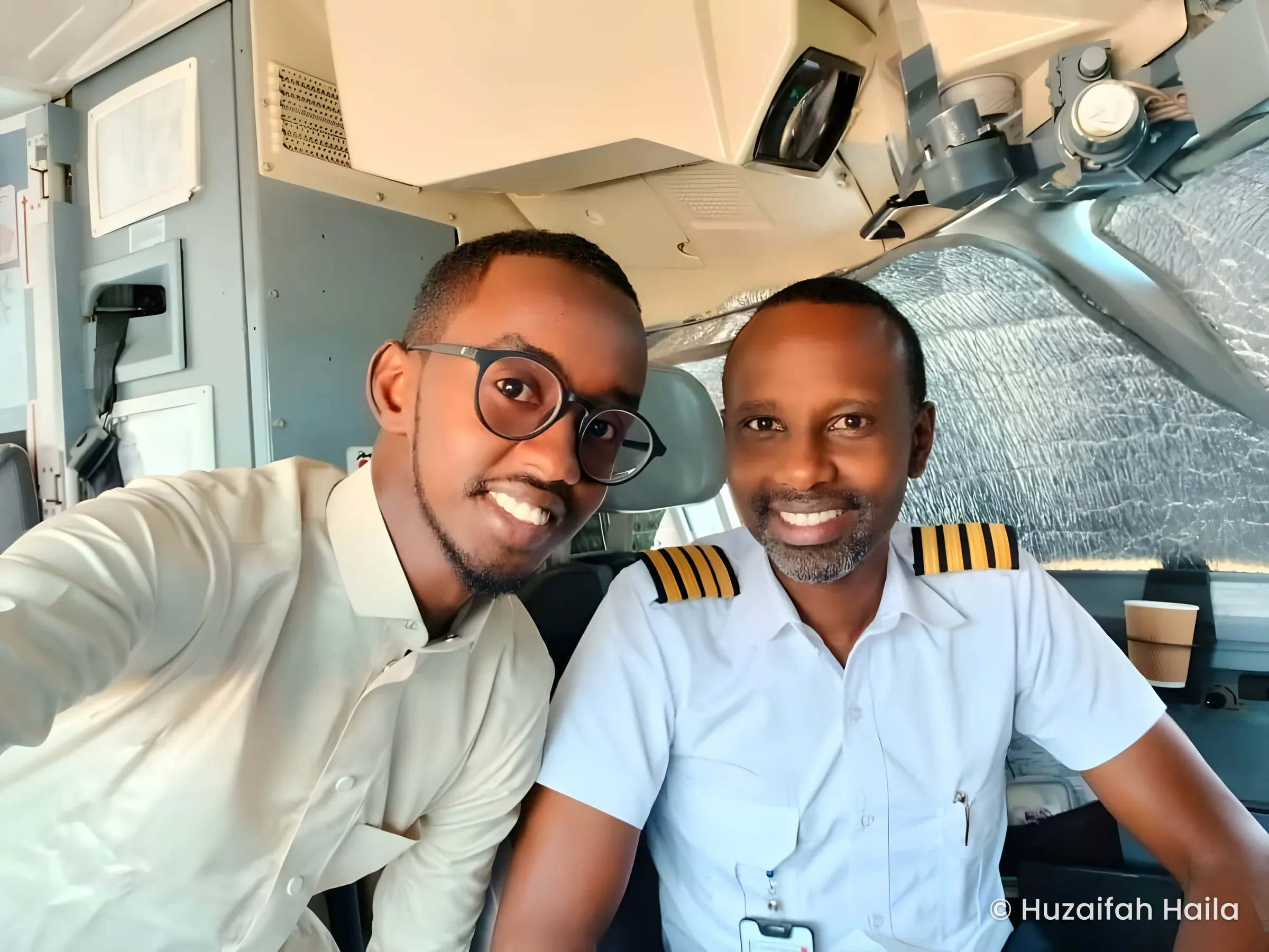 Huzaifah Haila with the pilot in the cockpit on the way to Bari